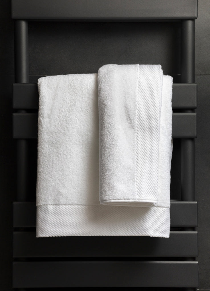 Two Inish Living luxury towels hanging on a towel rack