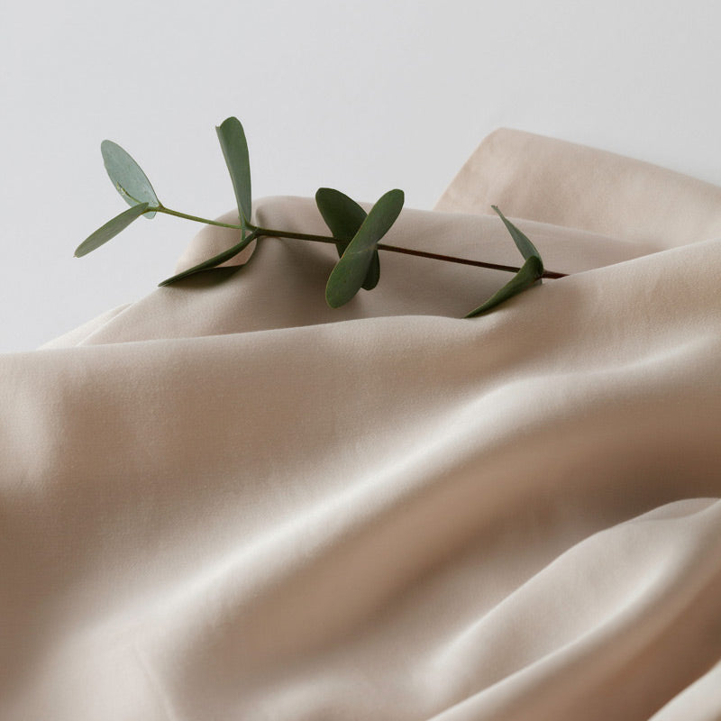 Silk like bed linen from Inish Living with a twig on top