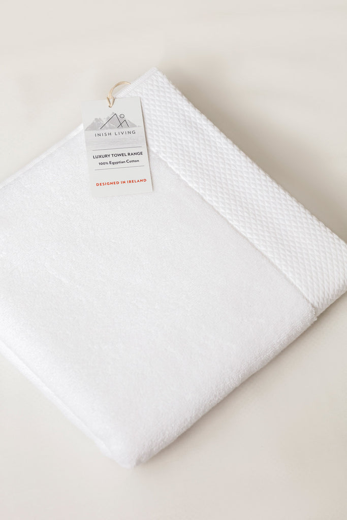 Inish Living luxury towel with a label on it