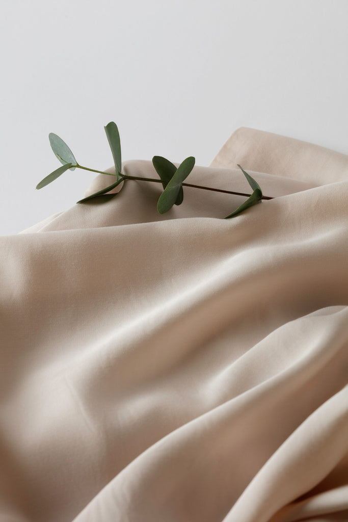 Silk like bed linen from Inish Living with a twig on top